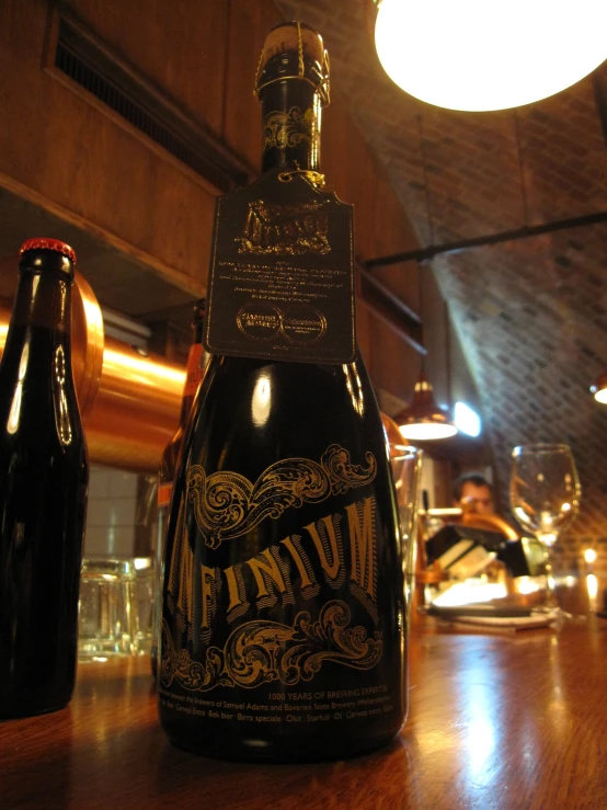 an opened bottle of wine and glasses on a table