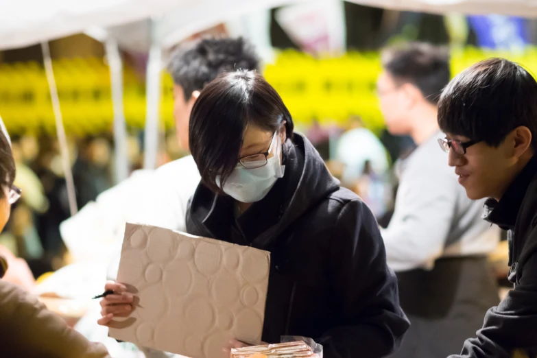 people at a table in an open market