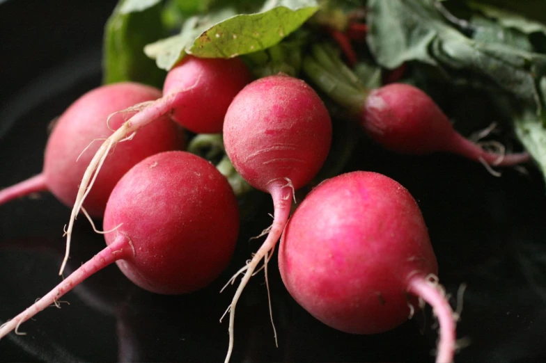 many red radishes are sitting next to each other