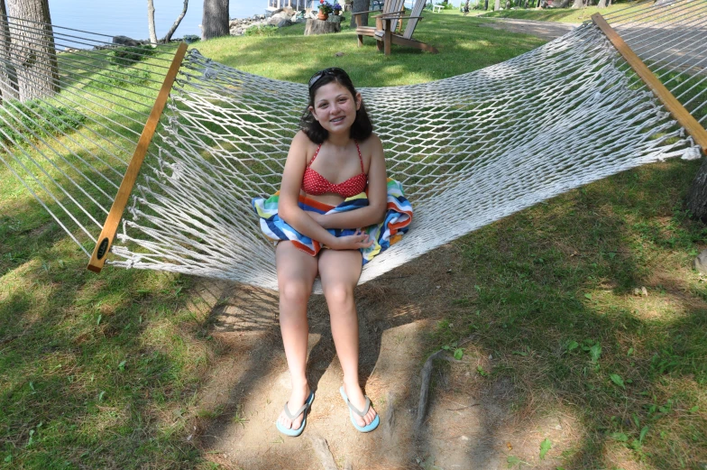 a woman laying in a hammock smiling