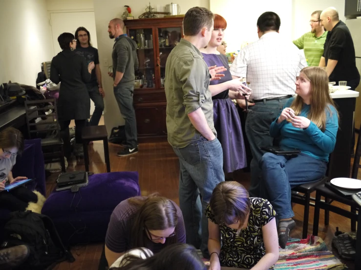 several people standing and talking in a room