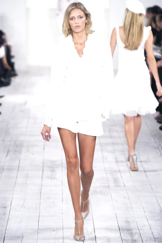 models walking down the runway at the white dress fashion show