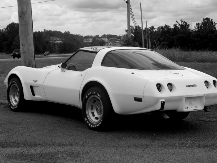 a white sports car sitting on the street