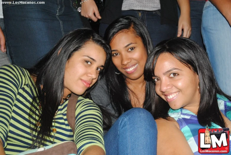 four women posing for a po on a couch