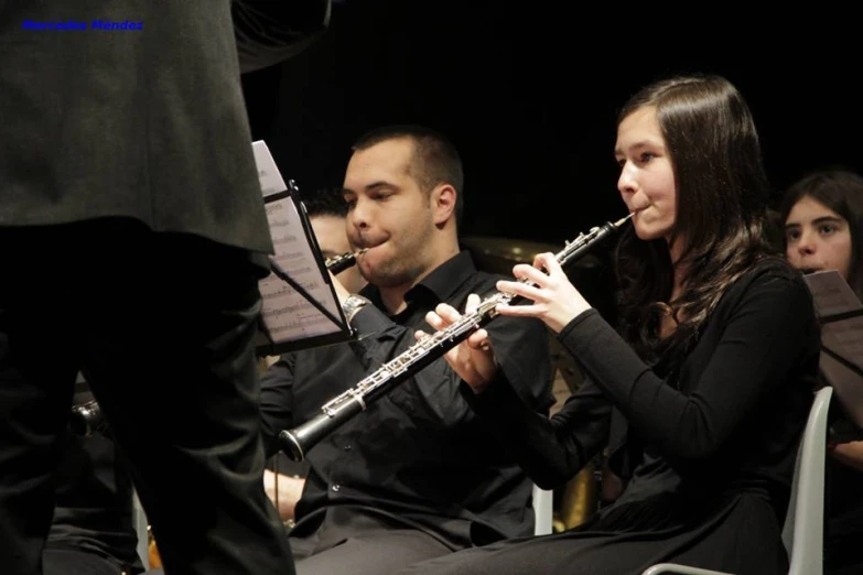 a couple plays flute together in an orchestra