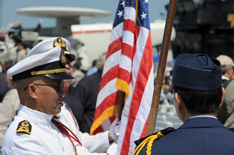 two military officers, one of whom has the american flag