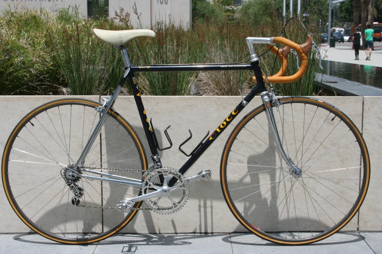 a bike parked against a brick wall outside