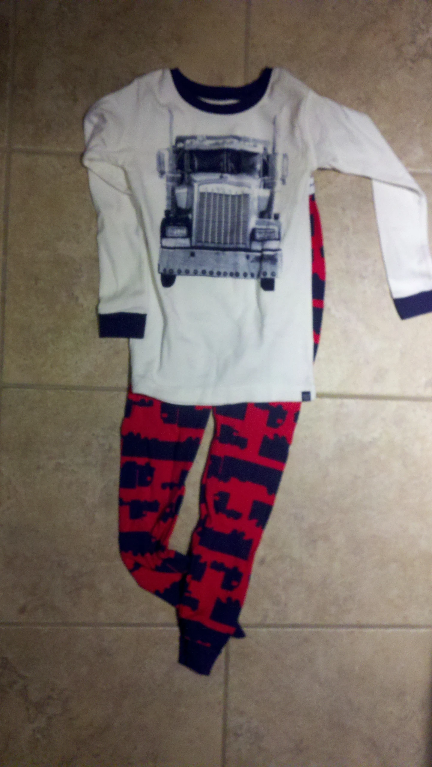 a pajamas set on the floor with red, black and white pattern