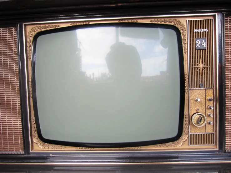 an old style television set sitting on a brick wall