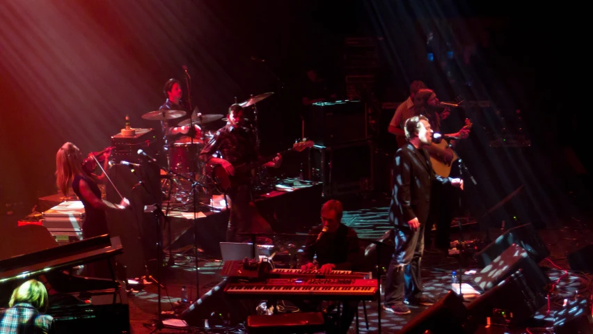 a band performing in a dark room with bright lights