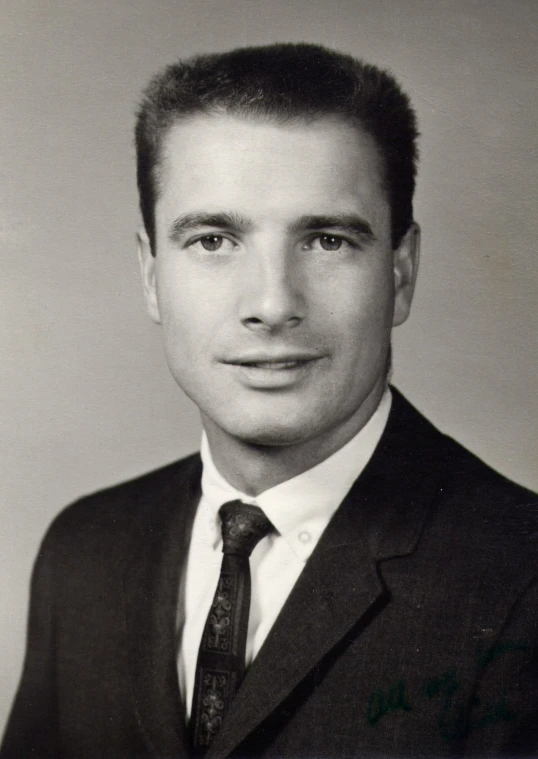 man in black suit and white shirt, with tie