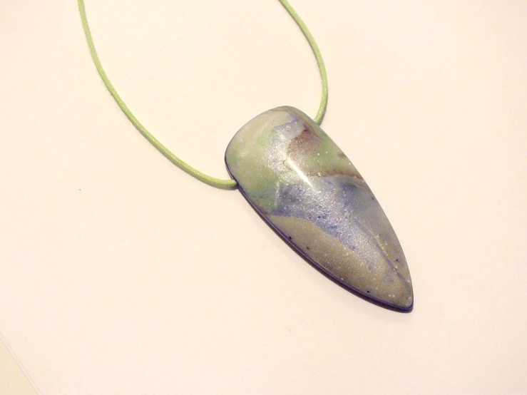 a necklace with a piece of marble on it