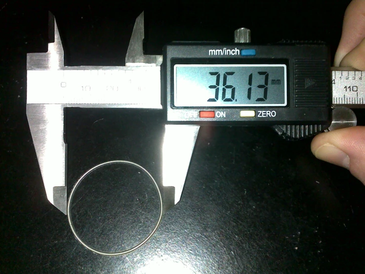 a measuring machine with a piece of tape wrapped around the handle