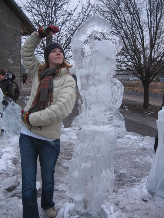 a woman standing by some snow and ice sculptures