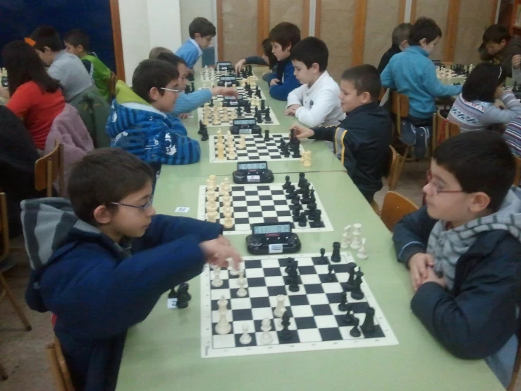 a group of s playing chess at a table