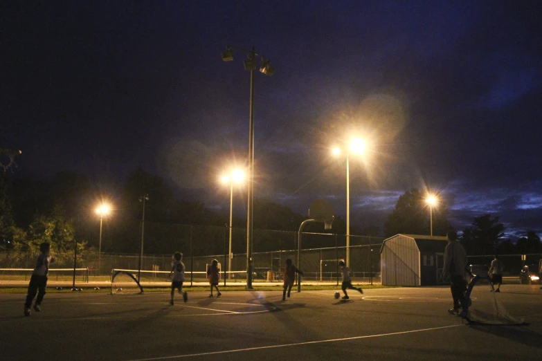 group of people in an outdoor space with lights on