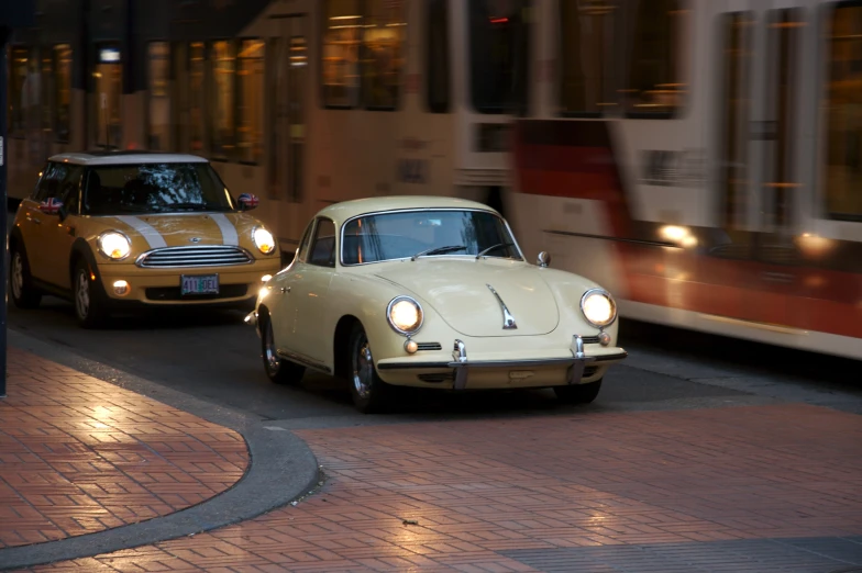 a car driving down a city street next to a train