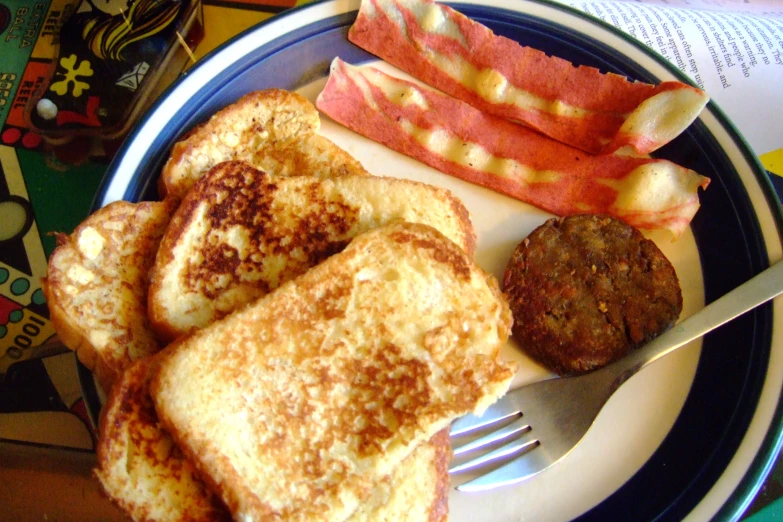 a plate with some french toast and vegetables