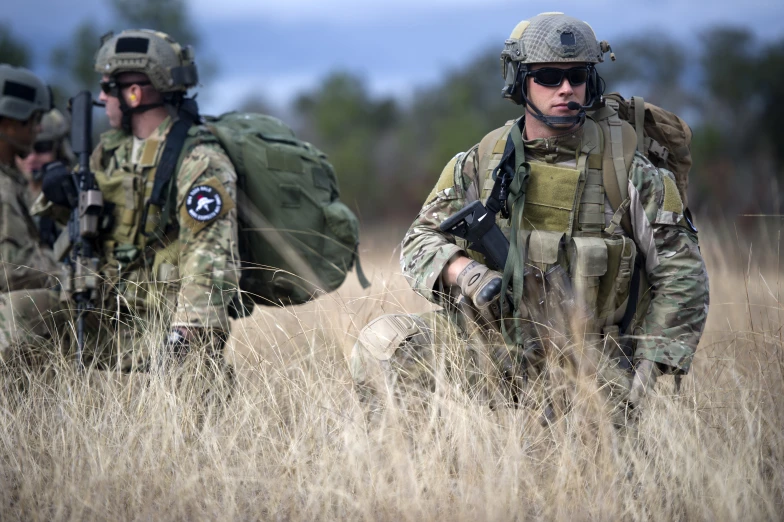 some military men in uniform and helmets