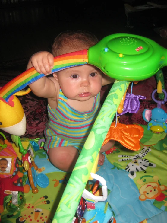 a baby holding onto the handle of a toy