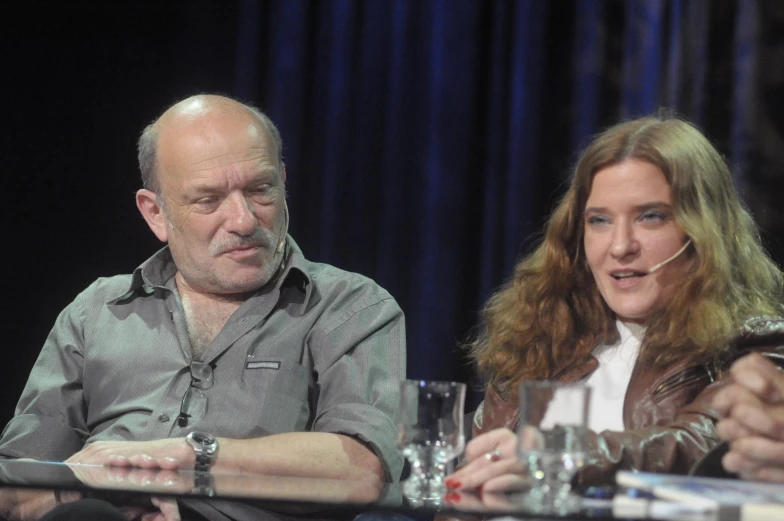 two people at a table with several drinks