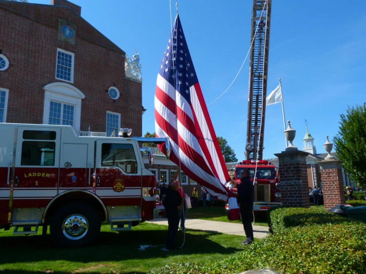 two people and a fire truck with an american flag