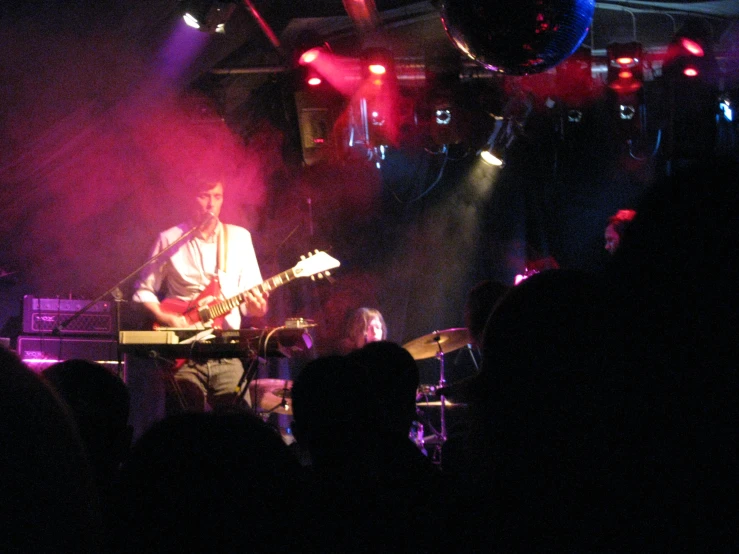 a musician plays a song on his guitar on stage