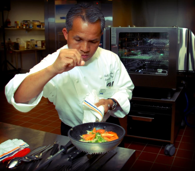 a chef stirring vegetable stir fry in a set