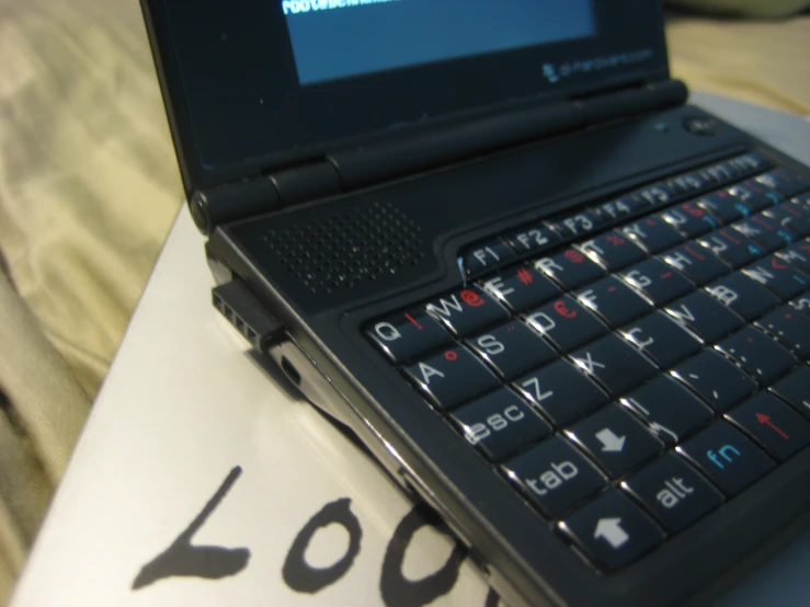 a laptop computer sitting on top of a pillow