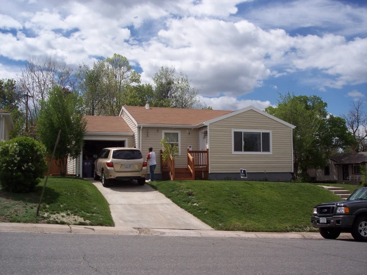 a small home with three cars parked in front