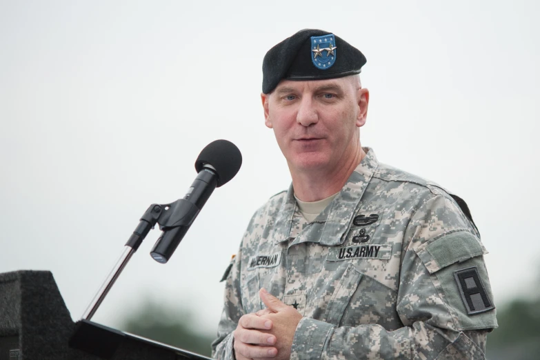 a man in uniform is talking into a microphone