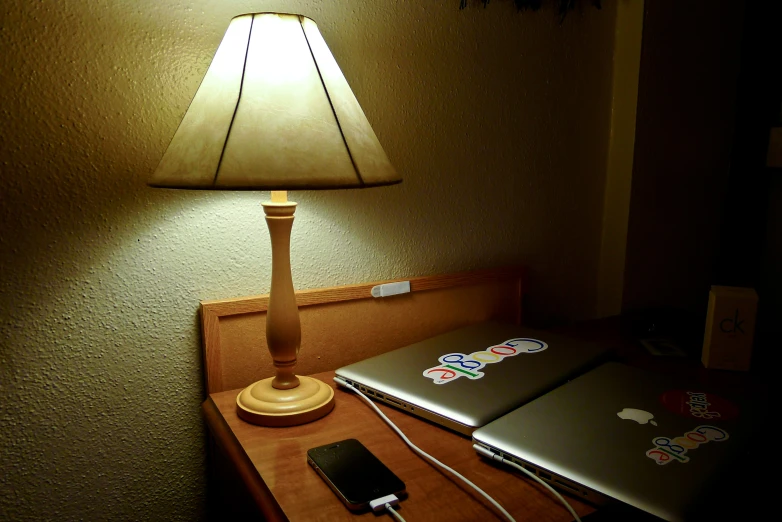 a small lamp and table with a laptop