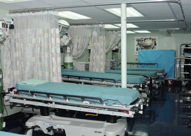 beds are in a hospital bed with curtains