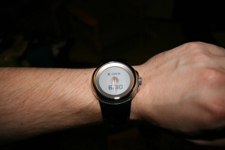 a person with a black and white wrist watch