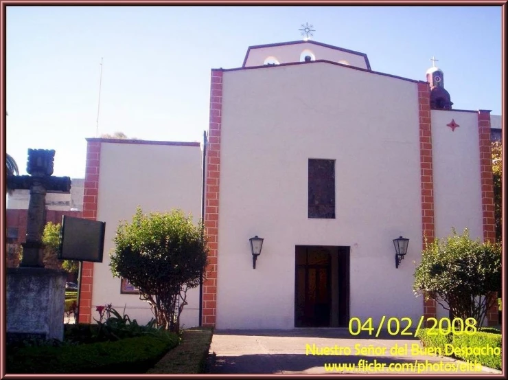 the front of a building with red bricks and a brown roof