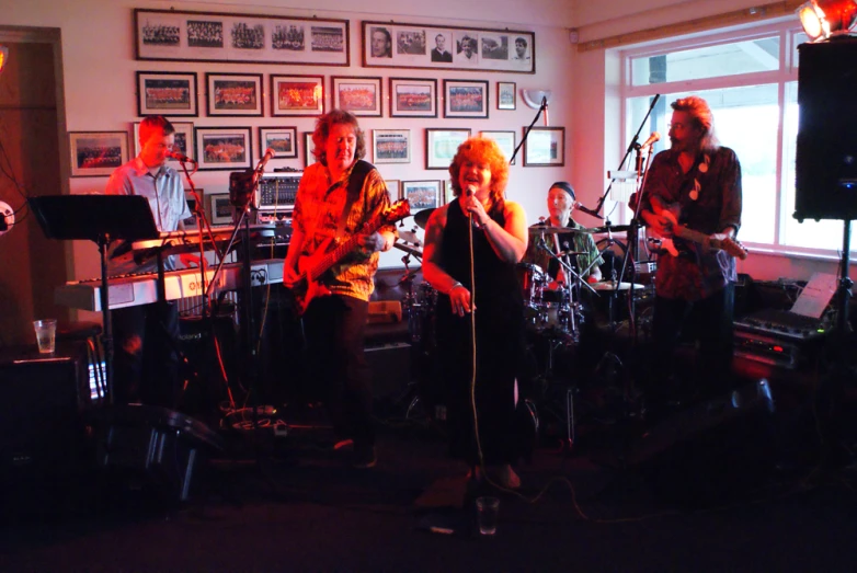 several people playing instruments in a dark room