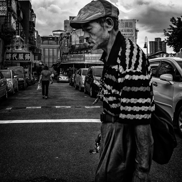 a black and white po of an older man wearing a knitted sweater