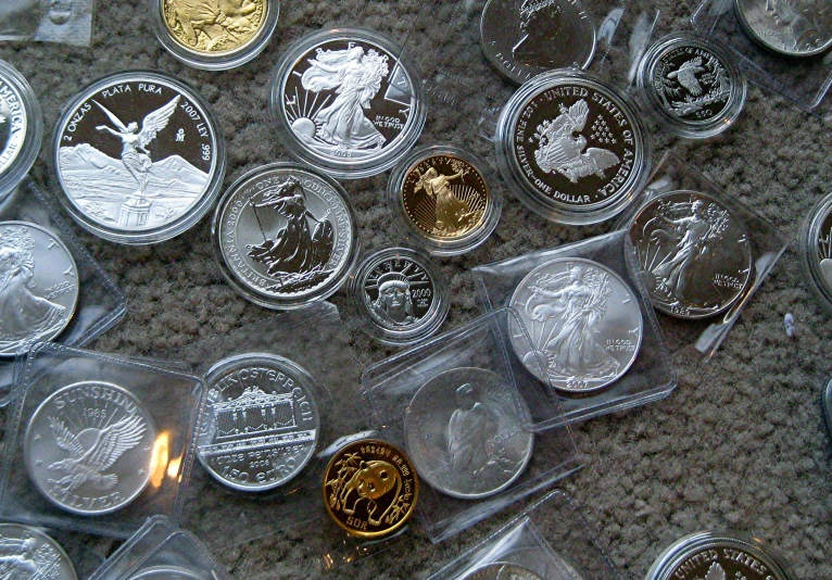 a collection of coins on display with plastic tray