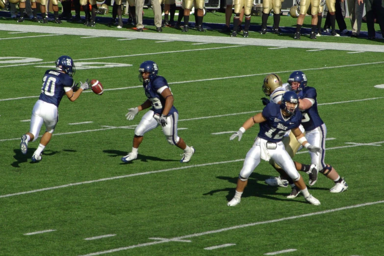 three football players are running on the field