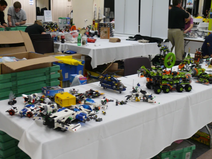 a table with legos on it and a long white table cloth