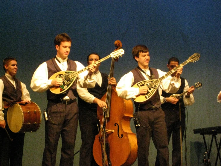 several male musical instruments and one male in a white shirt