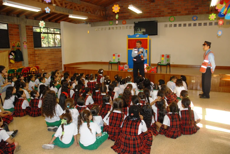 there is a man standing in front of a class of students