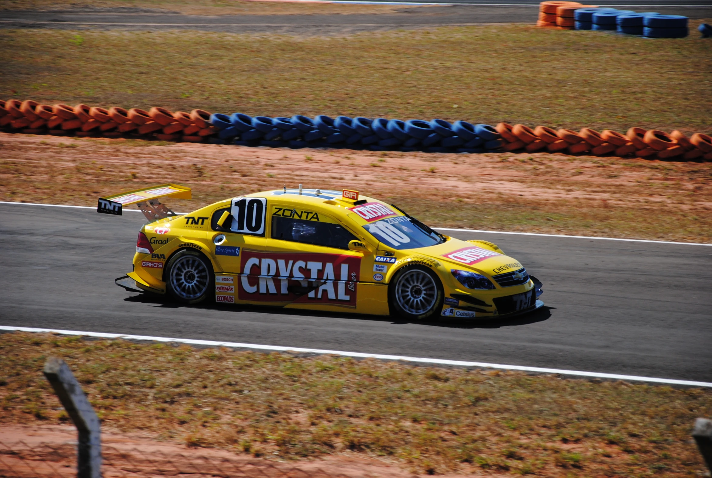 a yellow sports car racing on a track