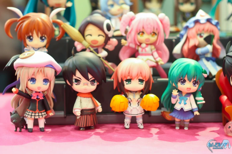 some cute dolls are sitting on a table