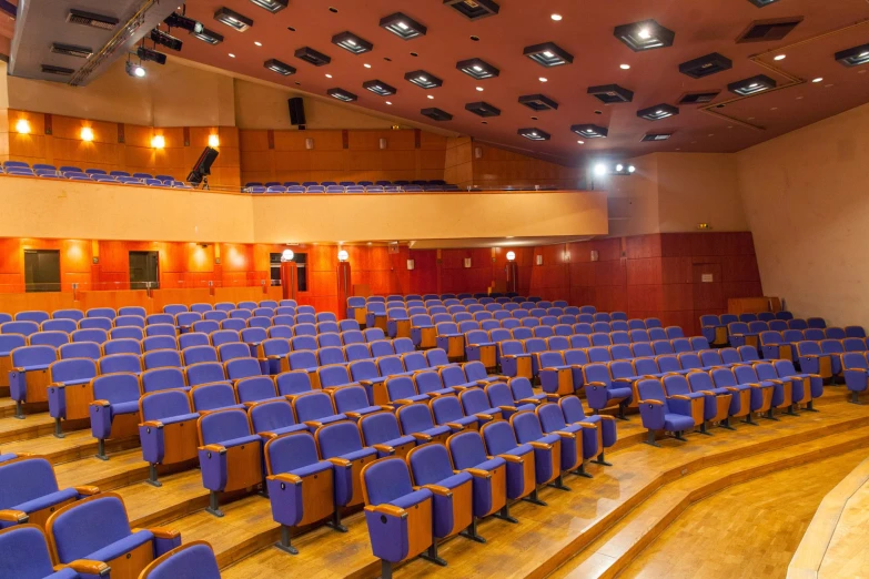 a room filled with lots of blue chairs