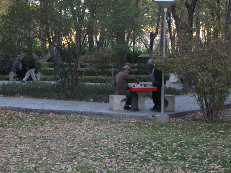 a person sitting at a table in the park