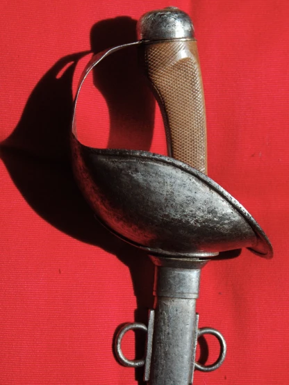 a metal object hanging on a red wall