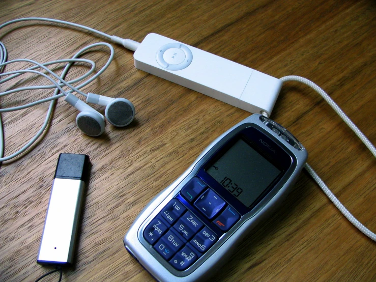 a cell phone and headphones next to each other