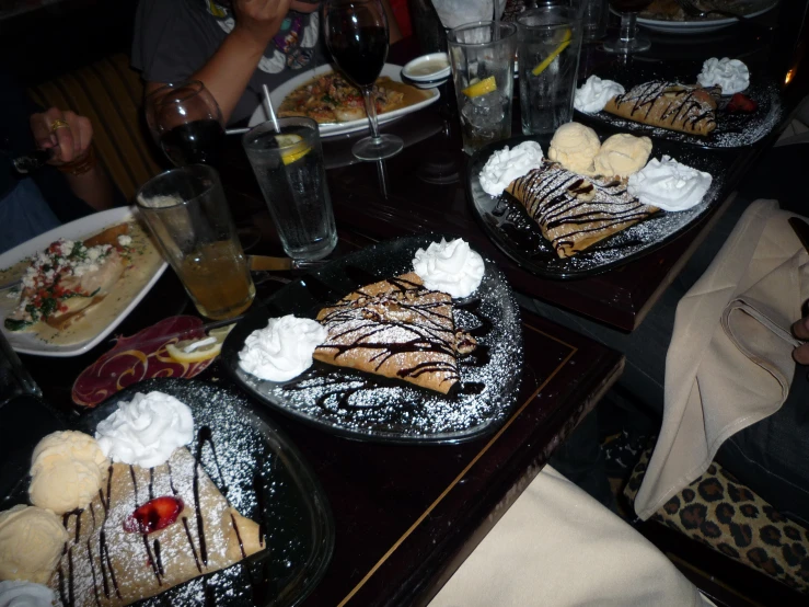 a table filled with desserts including banana bread and syrup