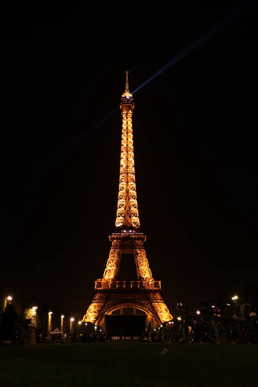 a very large illuminated tower at night in the dark